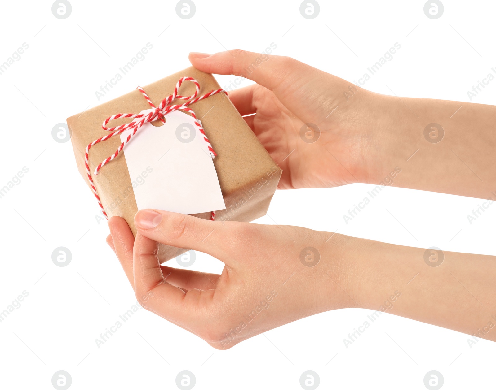 Photo of Woman holding parcel wrapped in kraft paper with tag on white background, closeup