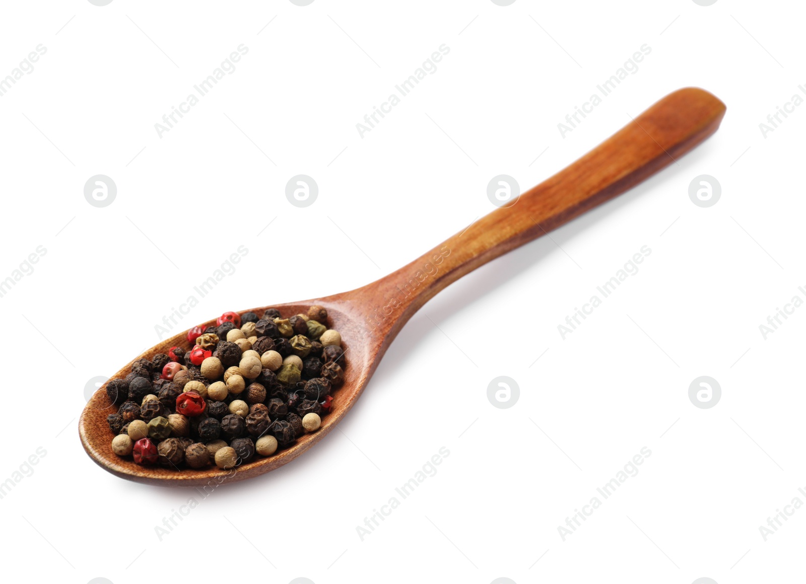 Photo of Aromatic spices. Different peppers in wooden spoon isolated on white