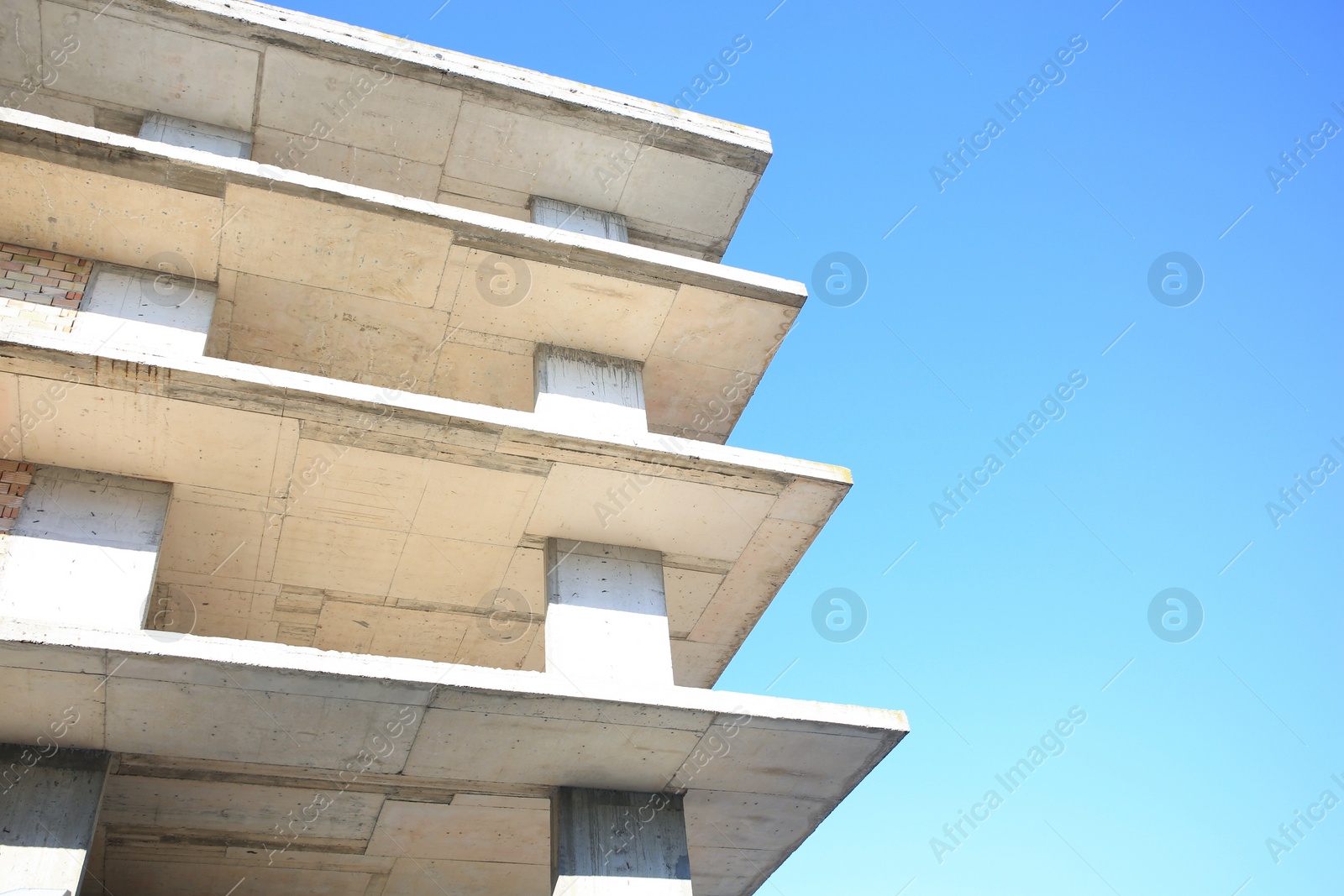 Photo of Exterior of reconstruction building against blue sky, low angle view. Space for text