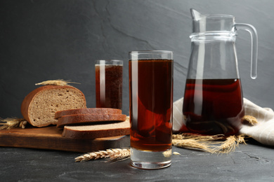 Delicious kvass, spikes and bread on black table