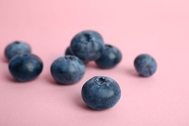 Photo of Tasty ripe blueberry on color background, closeup