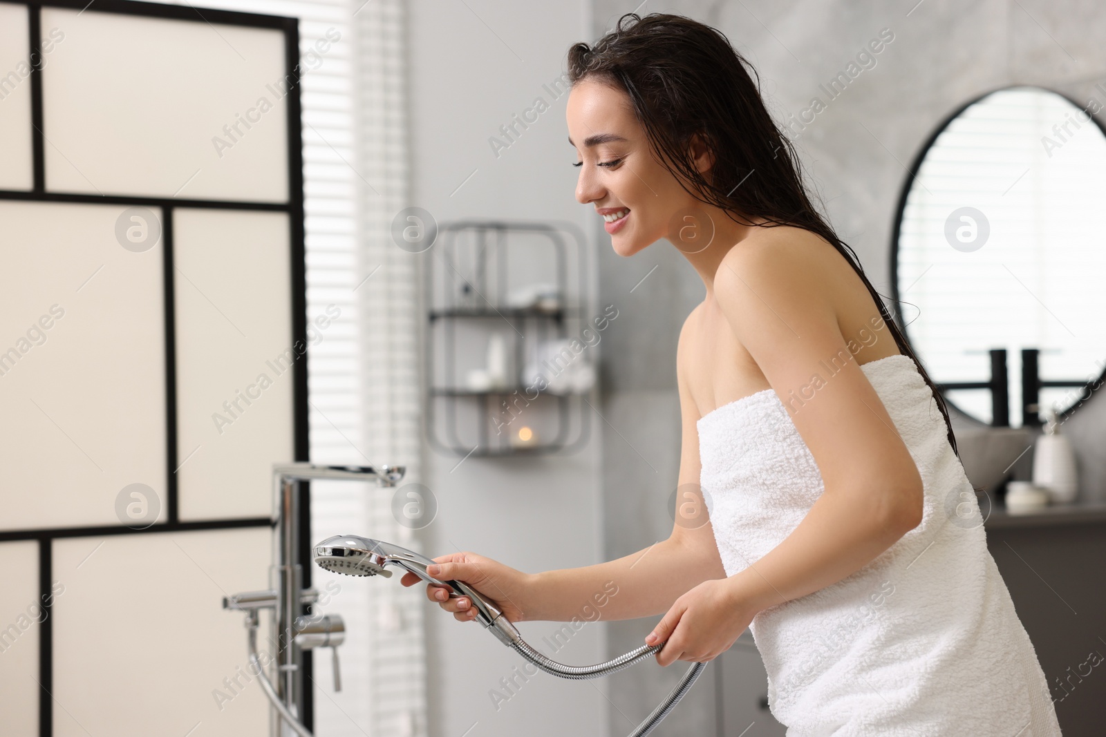 Photo of Smiling woman after shower in bathroom. Space for text