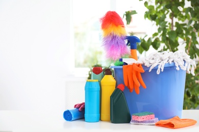 Photo of Set of cleaning supplies on table indoors