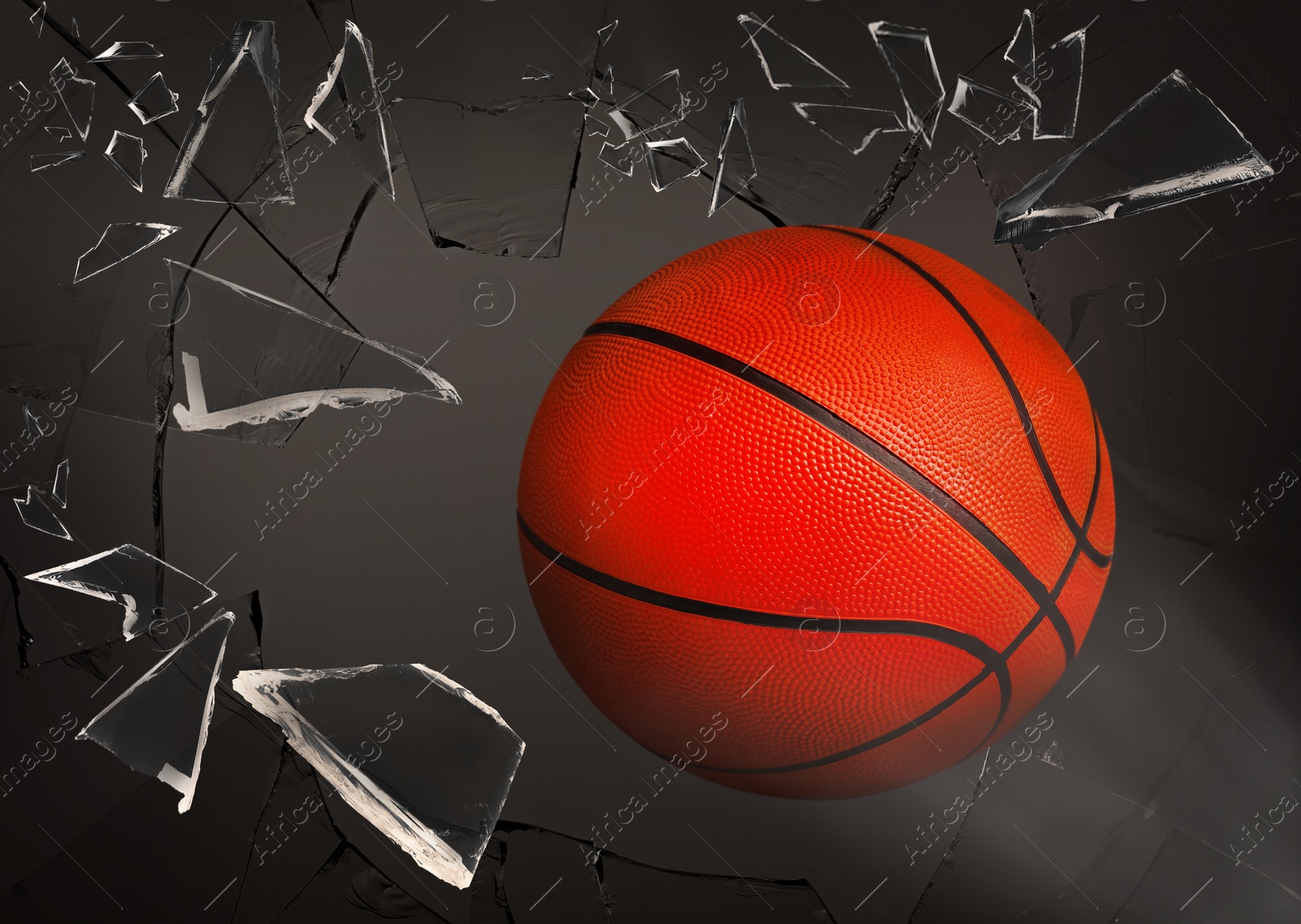 Image of Basketball ball breaking up glass against grey background