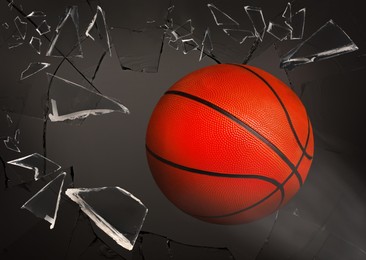 Image of Basketball ball breaking up glass against grey background