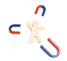 Photo of Red and blue horseshoe magnets with wooden human figure on white background, top view