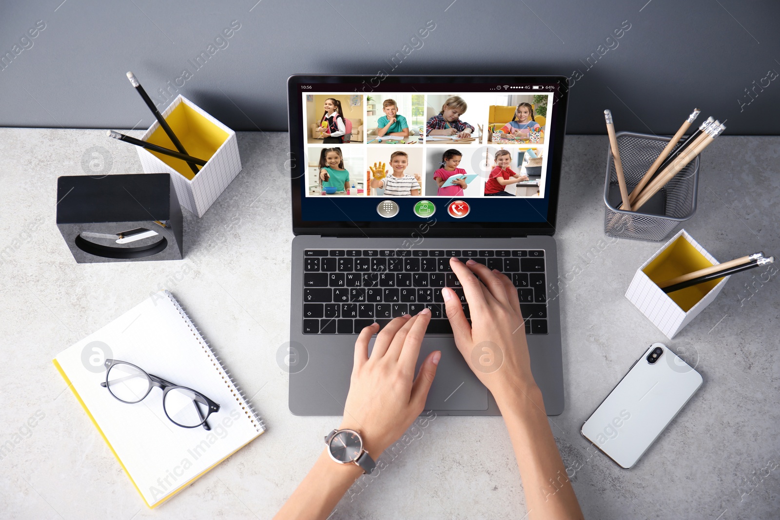 Image of Teacher giving online school lesson during quarantine and social distancing due to Covid-19 pandemic, top view. Pupils studying at home via video conference