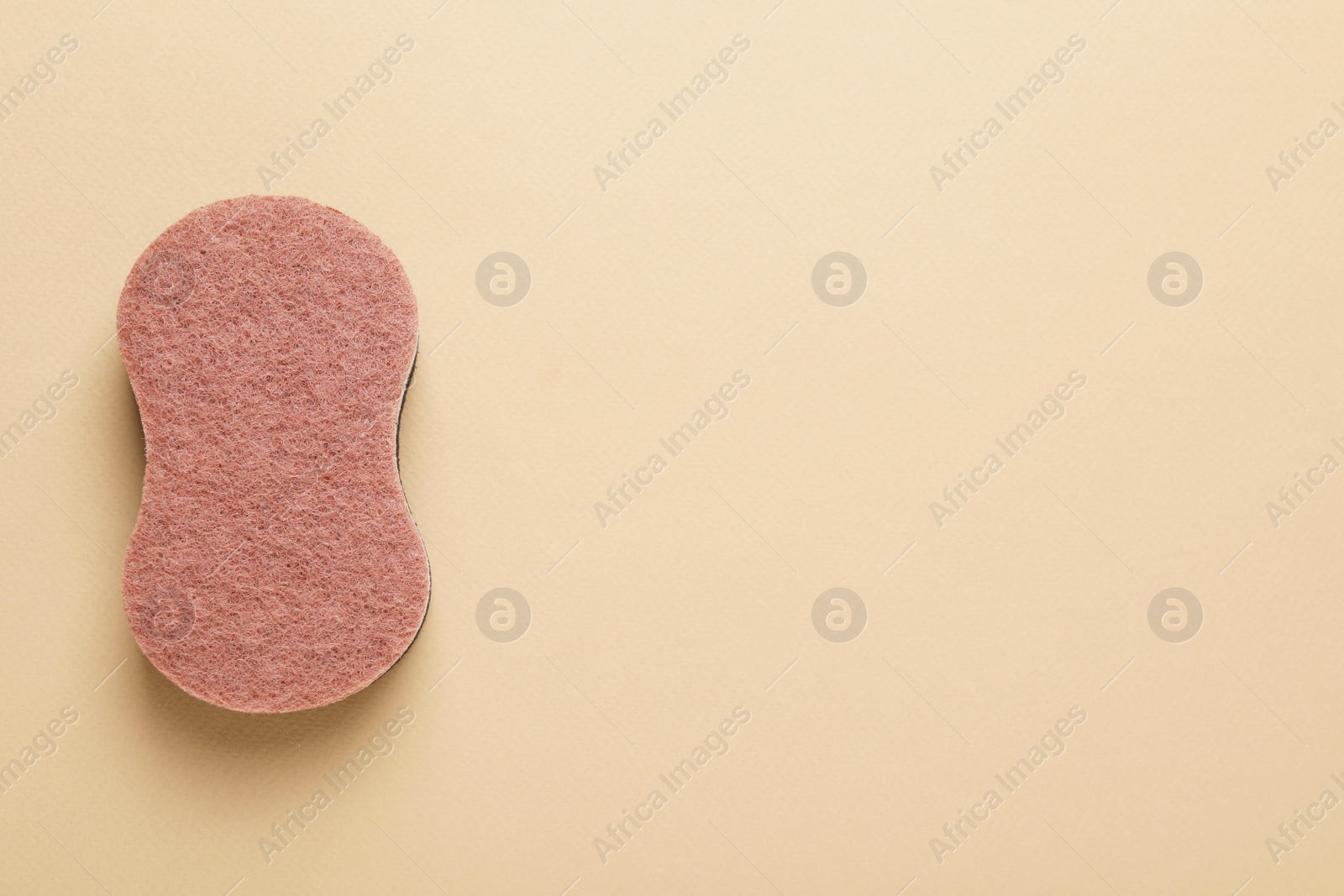 Photo of New sponge on beige background, top view. Space for text