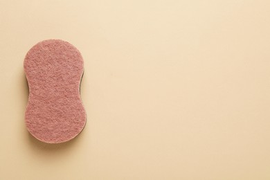 Photo of New sponge on beige background, top view. Space for text