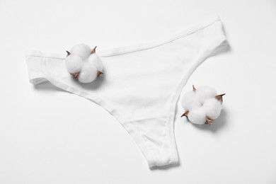 Photo of Stylish women's underwear and cotton flowers on white background