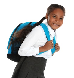 Happy African-American girl in school uniform on white background