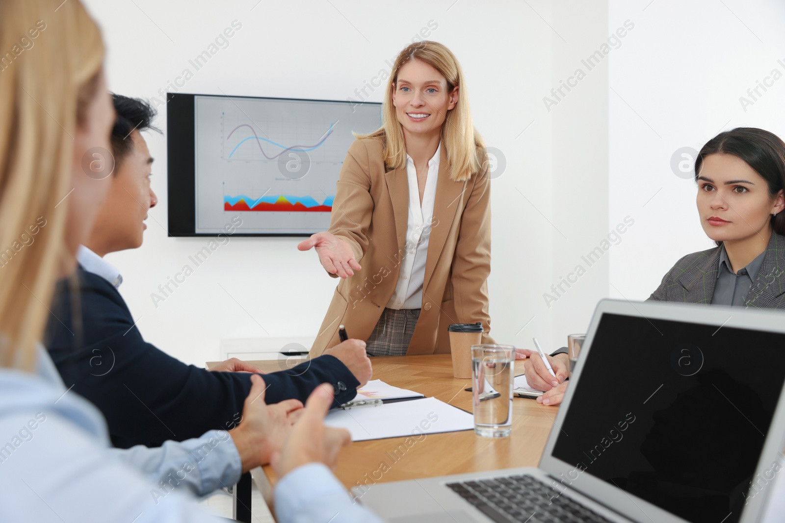 Photo of Businesswoman having meeting with her employees in office