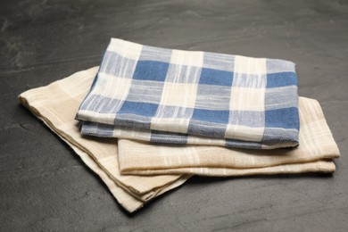 Beige and blue checkered kitchen towels on black table