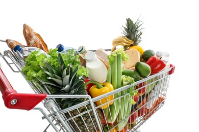 Photo of Shopping cart with groceries on white background