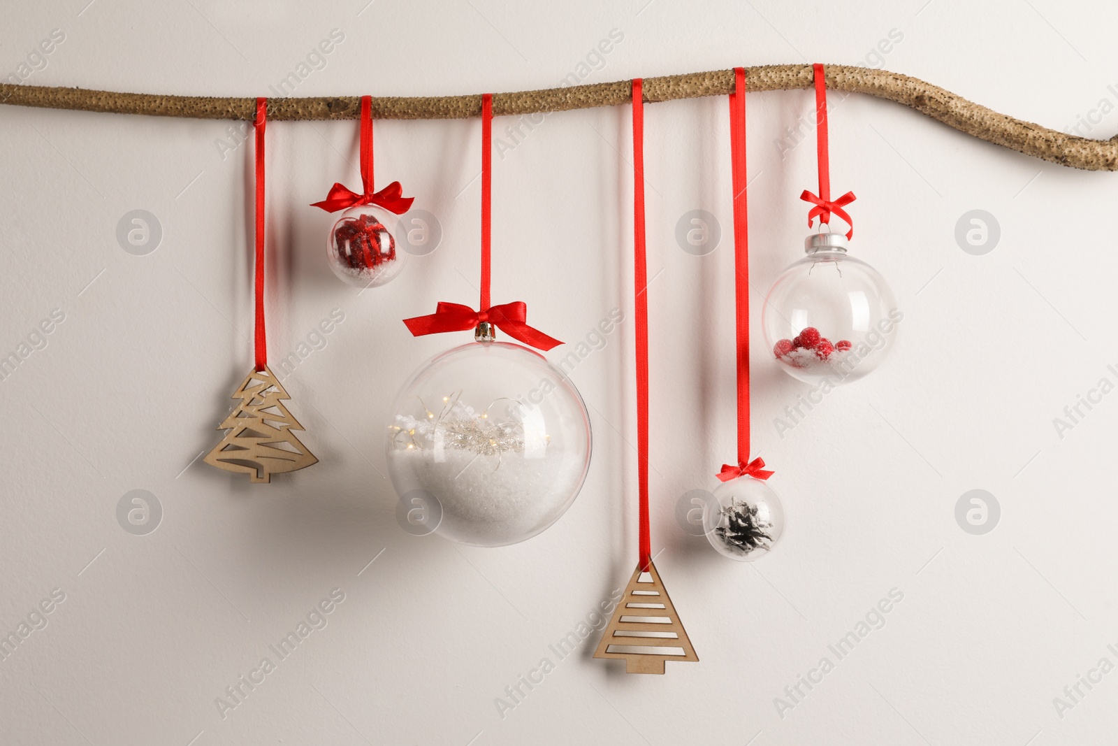 Photo of Decorative snow globes hanging on grey background