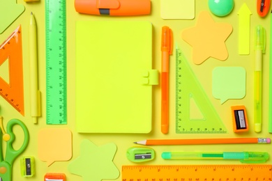 Photo of Flat lay composition with different school stationery on yellow background
