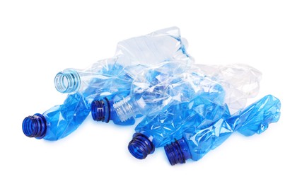 Photo of Crumpled disposable plastic bottles on white background