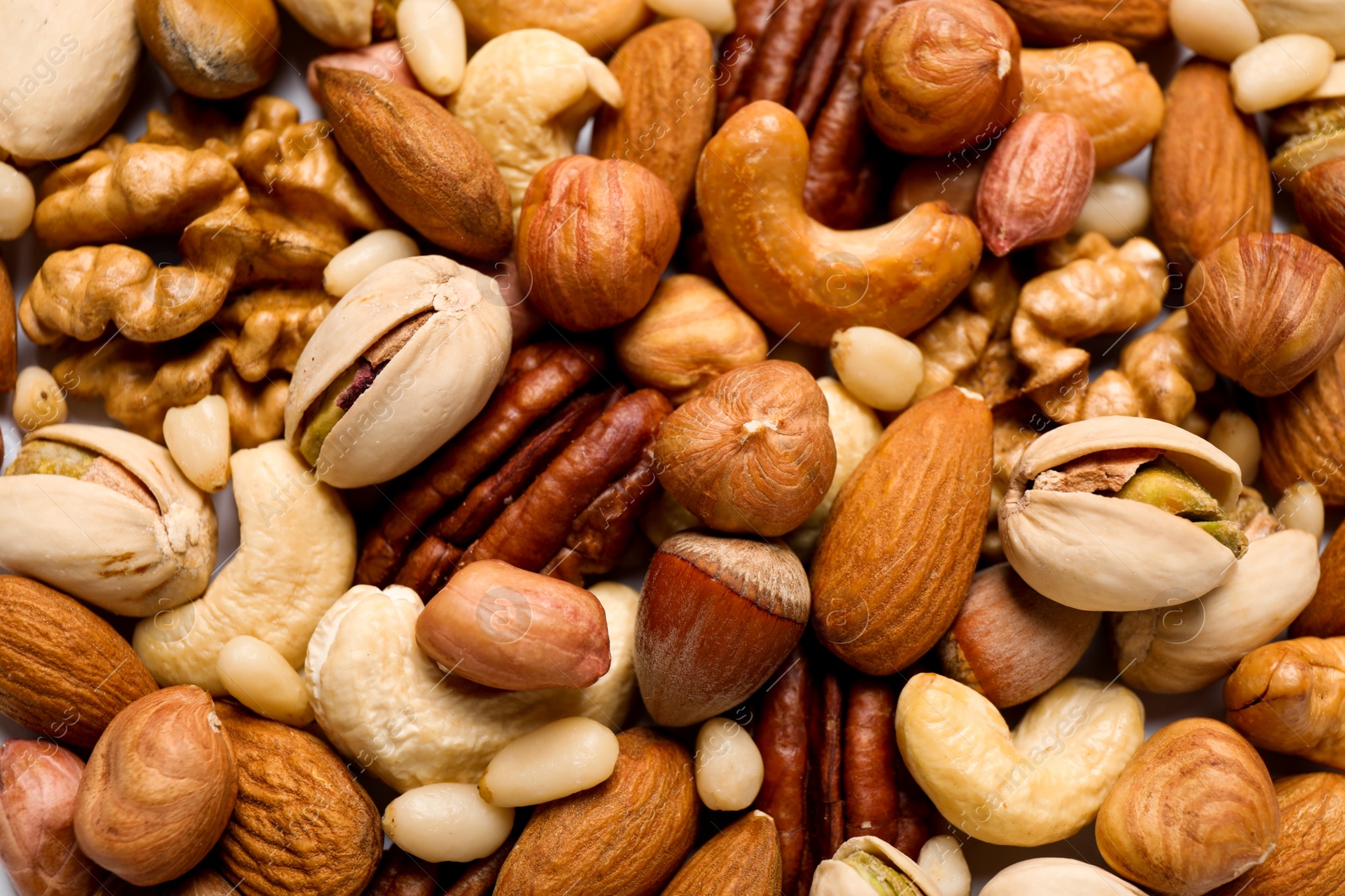 Photo of Different delicious nuts as background, closeup view