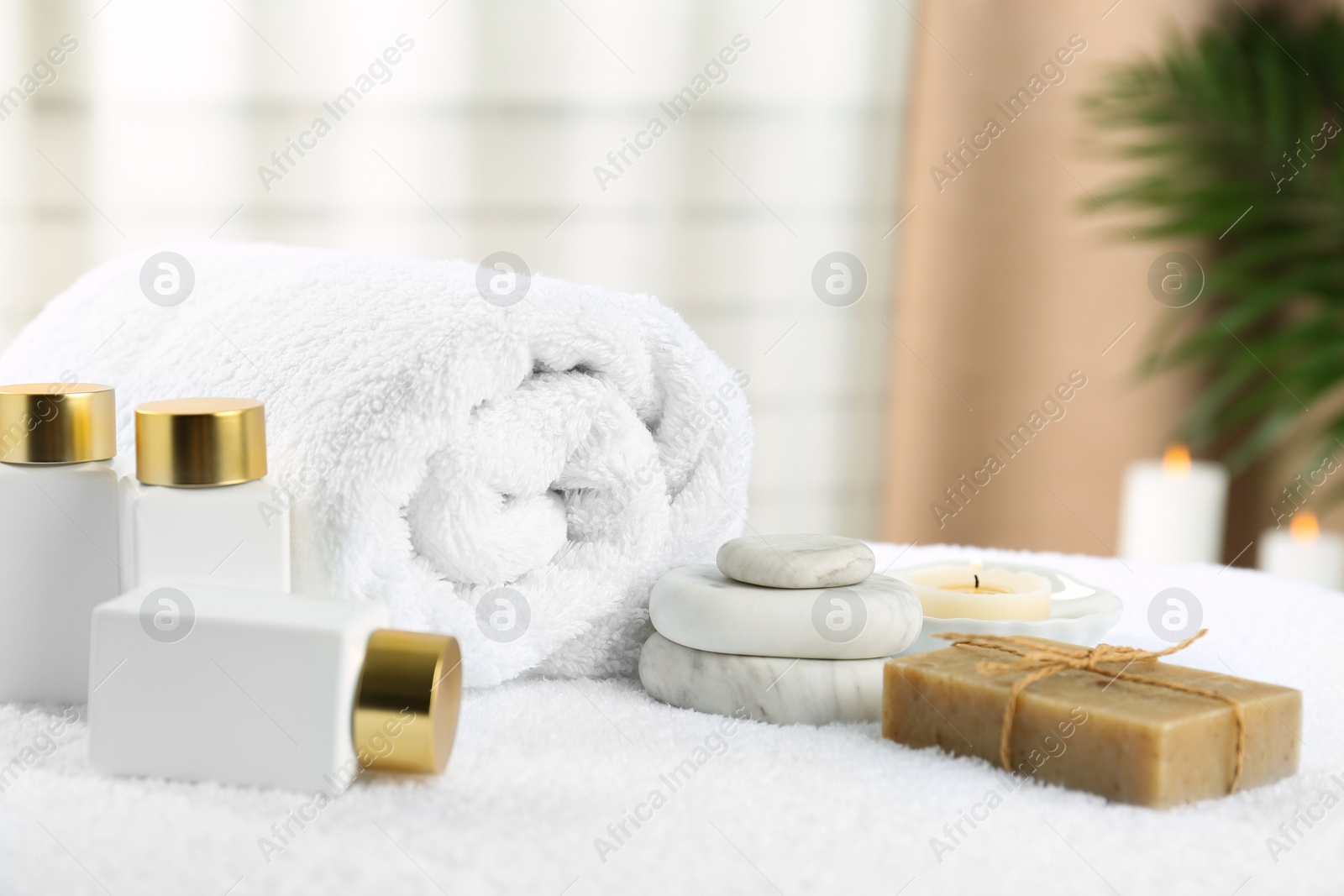 Photo of Composition with cosmetic products on white towel indoors. Spa therapy