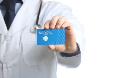 Photo of Doctor holding business card isolated on white, closeup. Medical service