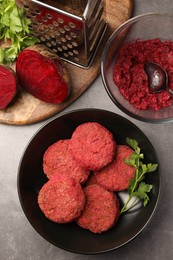 Photo of Delicious beetroot vegan cutlets and ingredients on light gray table, flat lay