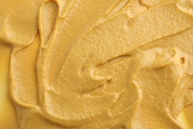 Photo of Fresh tasty mustard sauce as background, top view