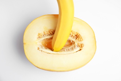 Photo of Fresh melon and banana on white background, top view. Sex concept