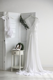 Wedding dress, high heel shoes and veil indoors