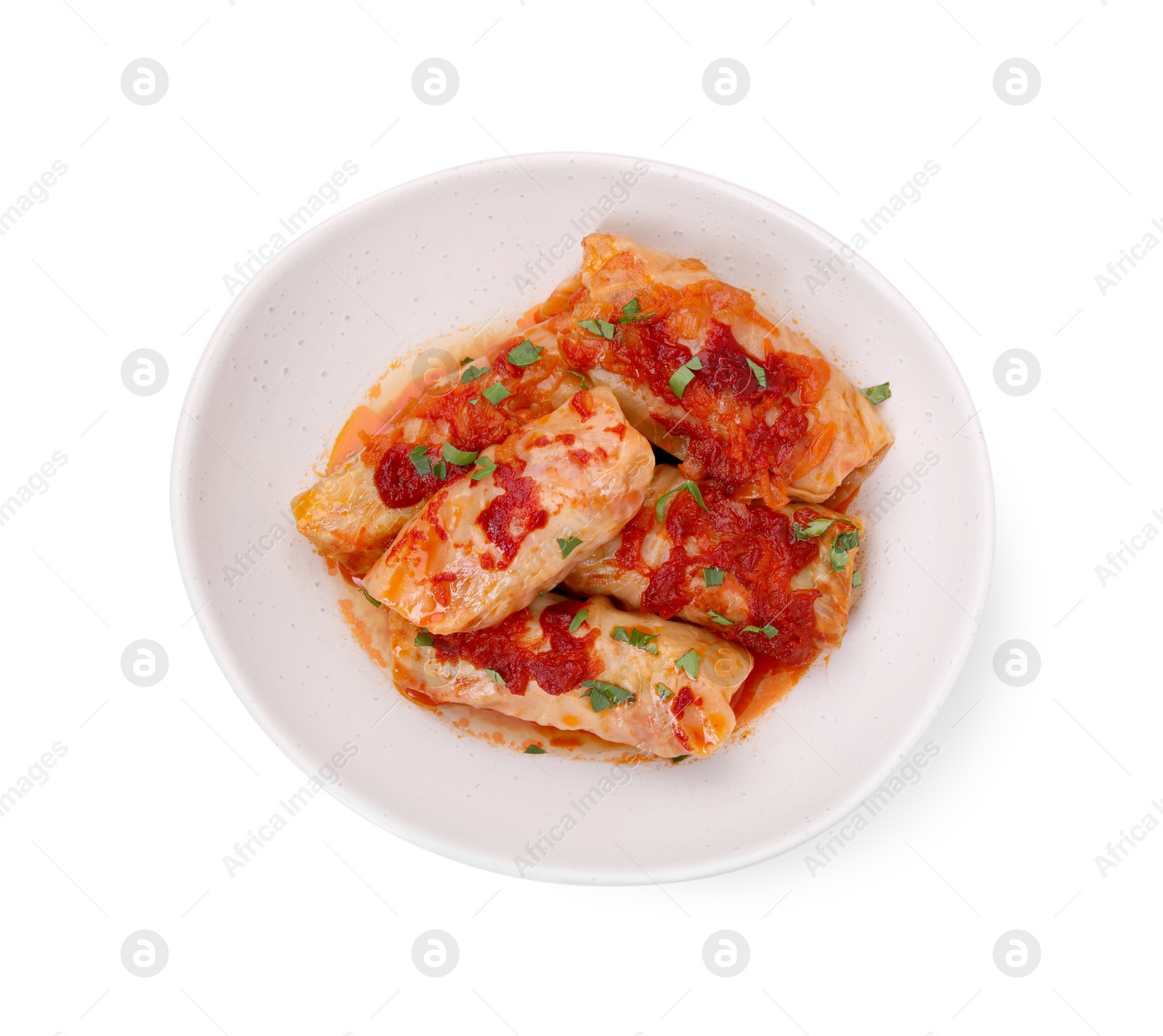 Photo of Plate of delicious stuffed cabbage rolls cooked with homemade tomato sauce isolated on white, top view