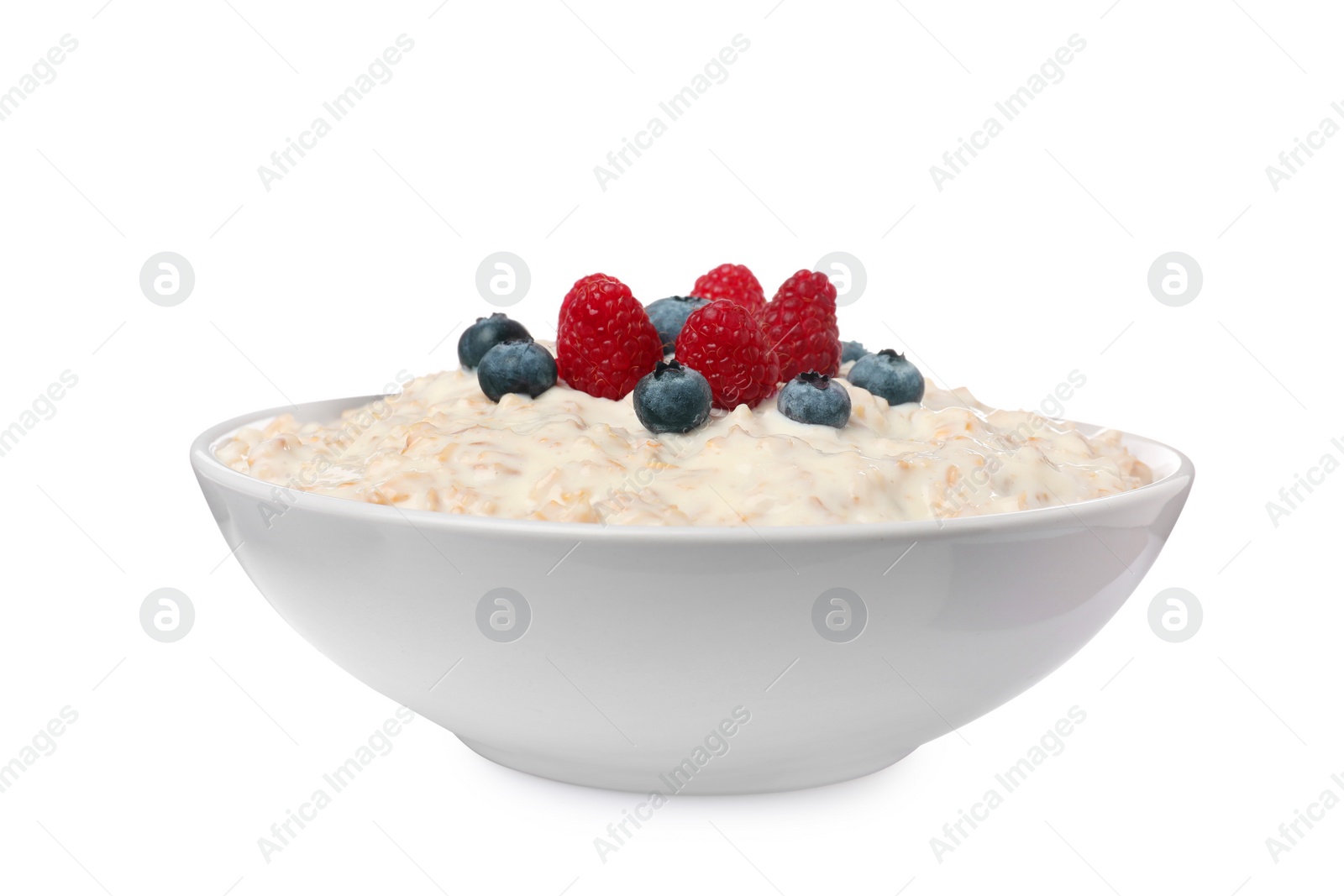 Photo of Tasty boiled oatmeal with berries in bowl isolated on white