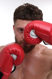 Man in boxing gloves on white background