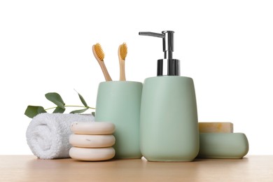 Bath accessories. Different personal care products and eucalyptus branch on wooden table against white background