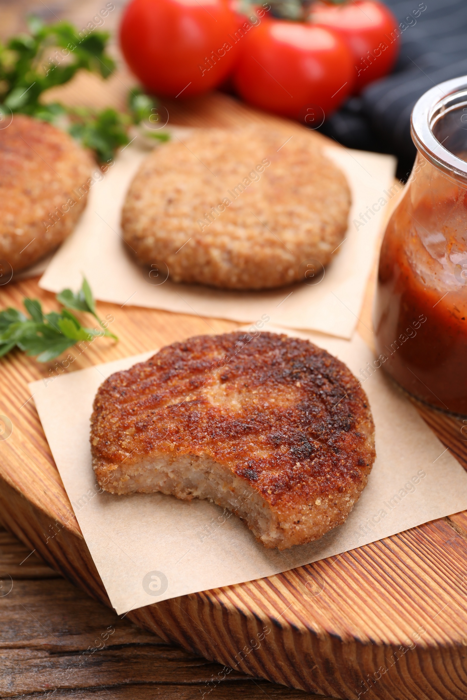 Photo of Delicious vegan cutlets on wooden table, closeup