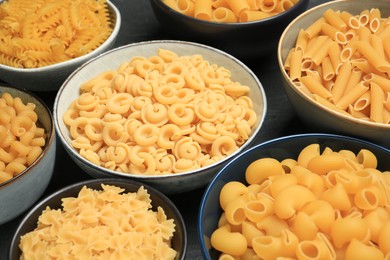 Different types of pasta on table, closeup