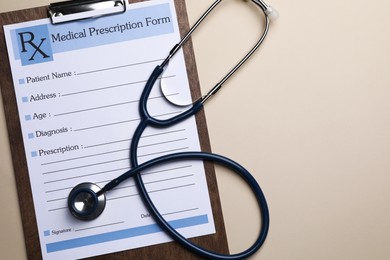 Photo of Clipboard with medical prescription form and stethoscope on beige background, flat lay. Space for text
