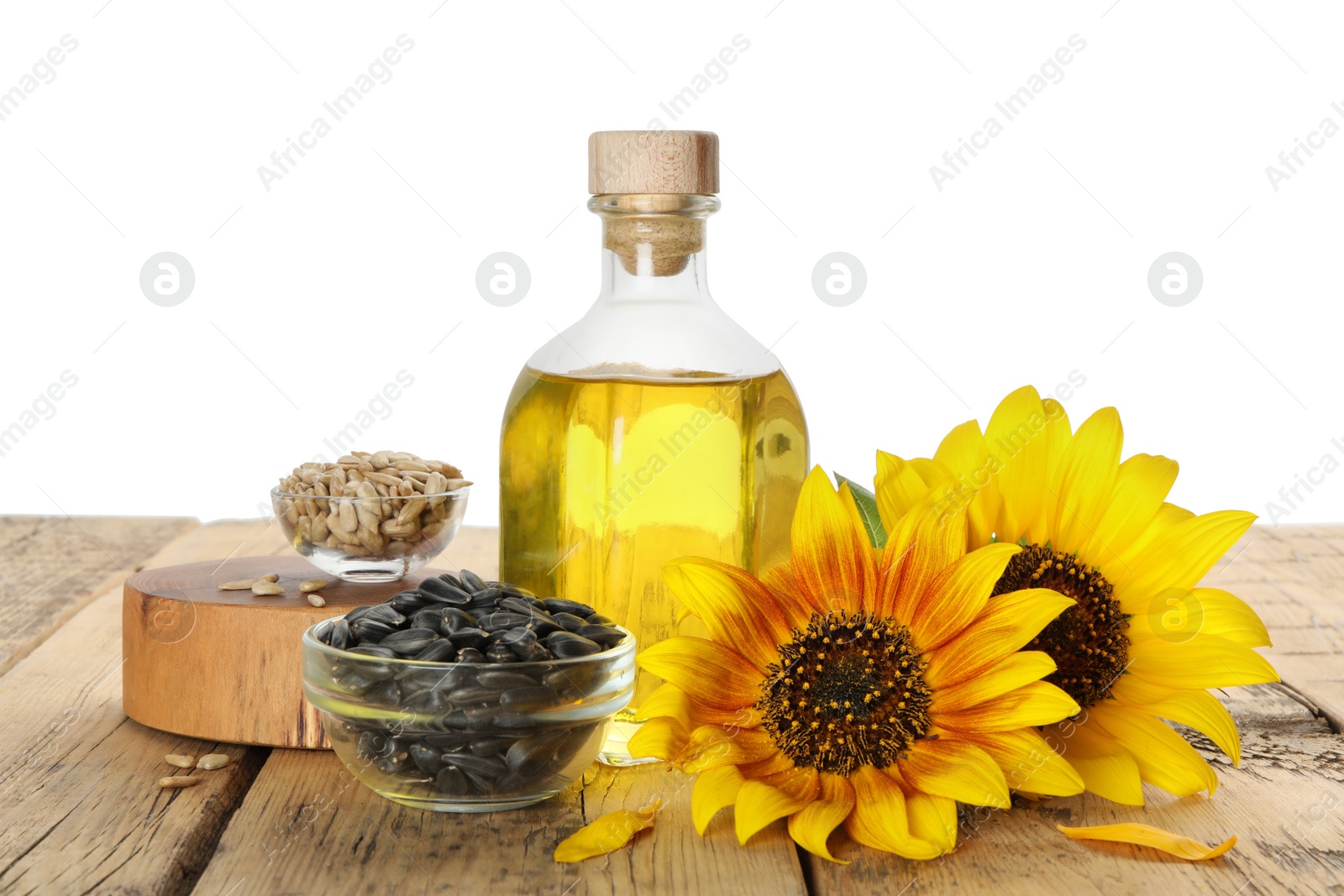 Photo of Composition with sunflower oil on wooden table against white background