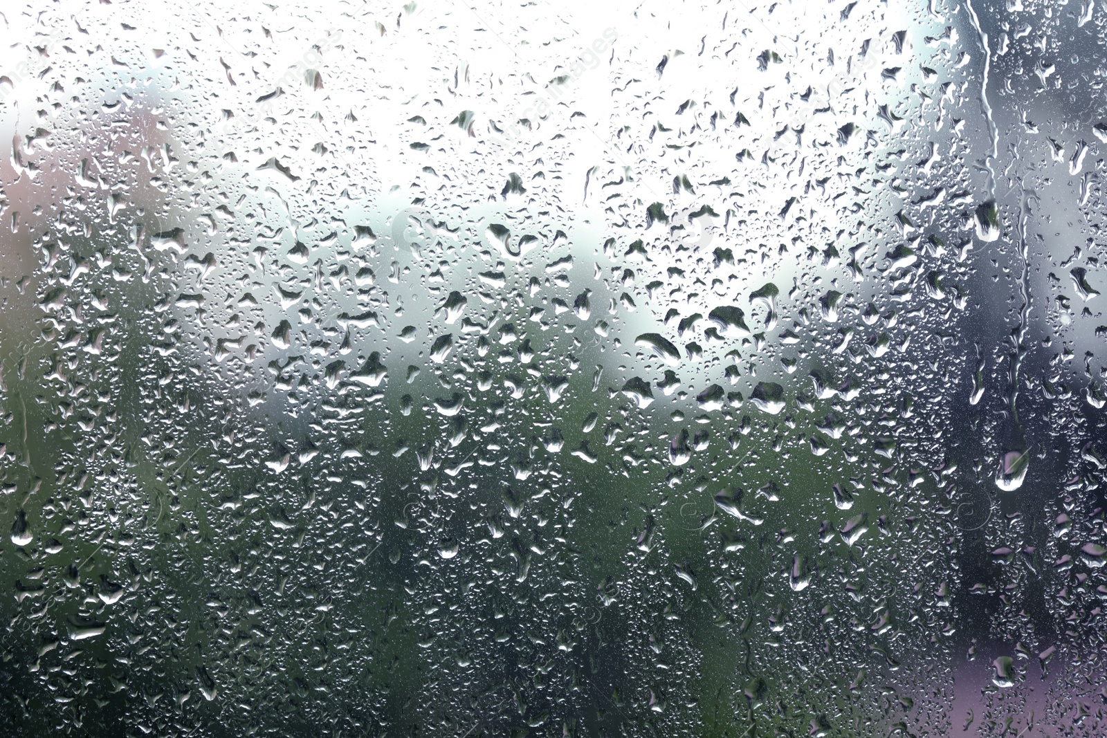 Photo of Window glass with raindrops as background, closeup