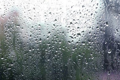 Photo of Window glass with raindrops as background, closeup