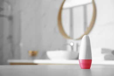 Deodorant container on table in bathroom. Space for text