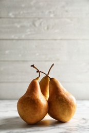 Ripe pears on marble table. Space for text