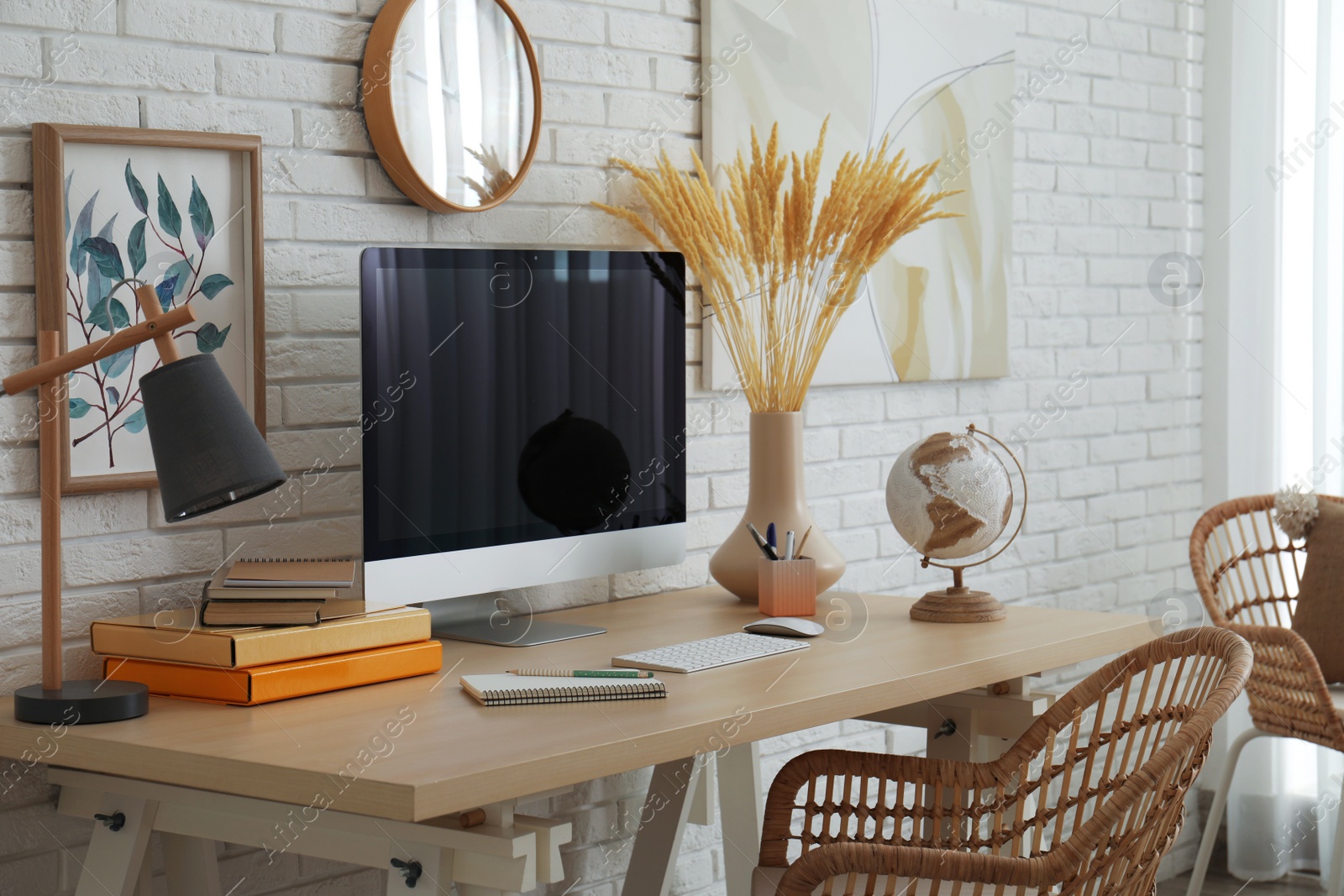 Photo of Stylish home office interior with comfortable workplace near white brick wall
