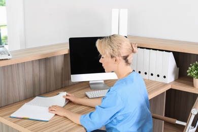 Photo of Female medical assistant at workplace in clinic. Health care service