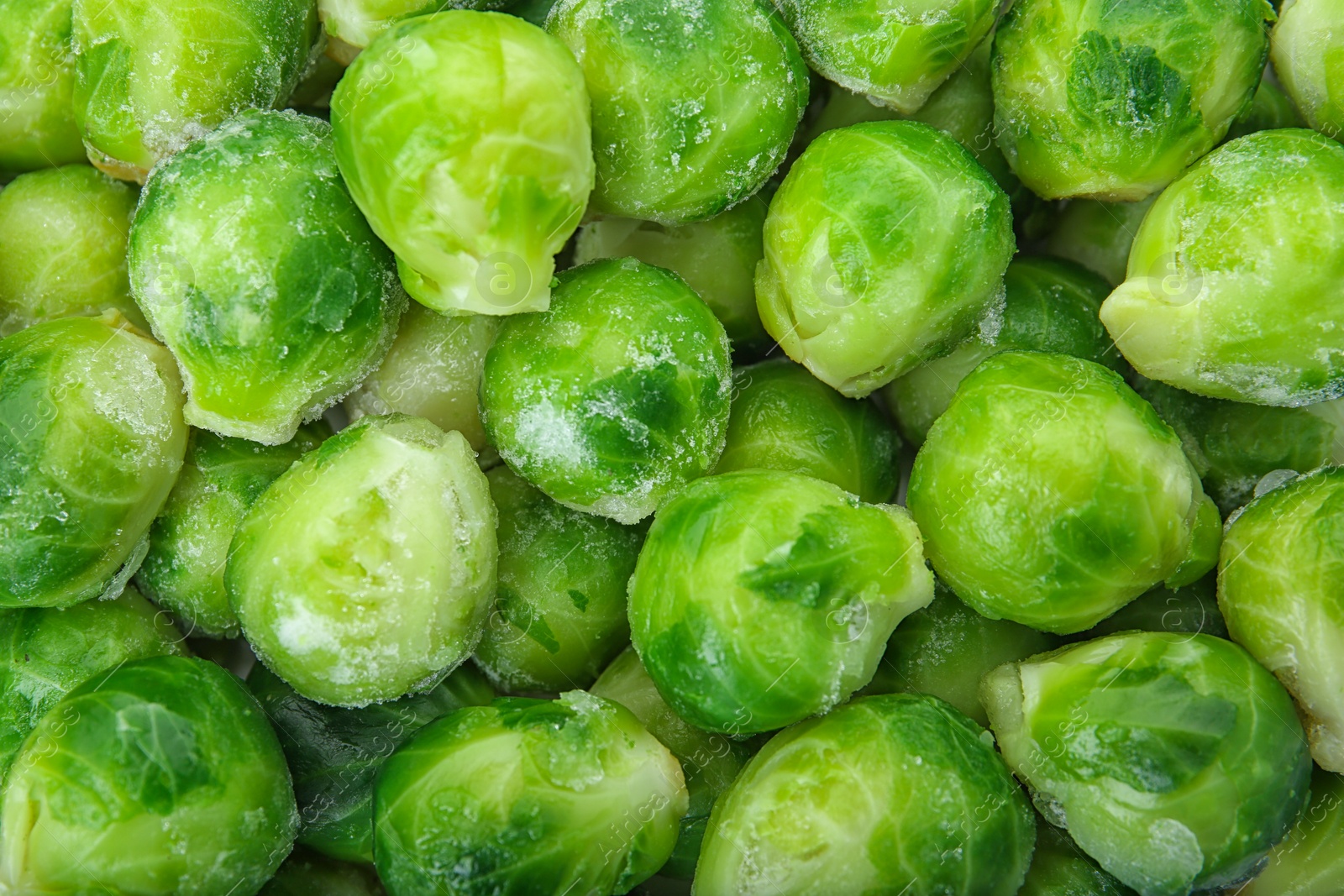 Photo of Frozen brussel sprouts as background, top view. Vegetable preservation