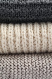 Photo of Soft knitted scarfs as background, closeup view