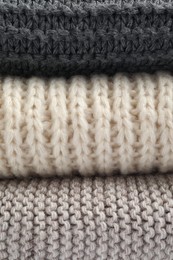 Soft knitted scarfs as background, closeup view