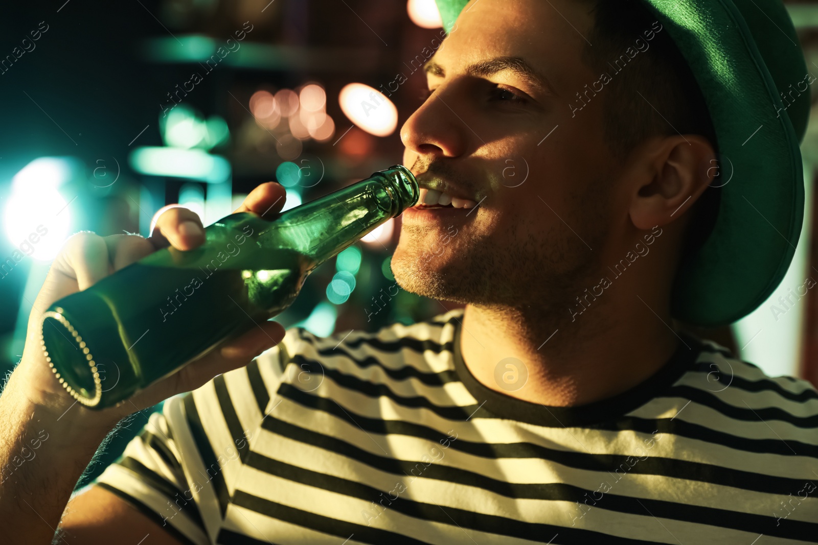 Photo of Man with beer celebrating St Patrick's day in pub, closeup