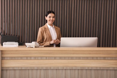 Photo of Portrait of receptionist at countertop in office