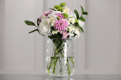 Photo of Bouquet of beautiful chrysanthemum flowers in vase on table