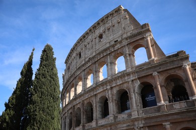 Rome, Italy - February 4, 2024 : Colosseum against light blue sky, low angle view