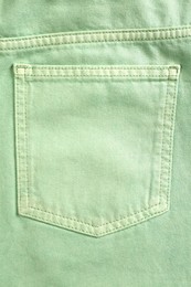 Photo of Light green jeans with back pocket as background, closeup